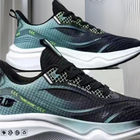Load image into Gallery viewer, A pair of athletic sneakers shown in a clean studio-style setting. The shoes have a dark navy and black mesh upper with a teal-to-light-blue gradient overlay, white midsoles, and small neon green graphic accents.