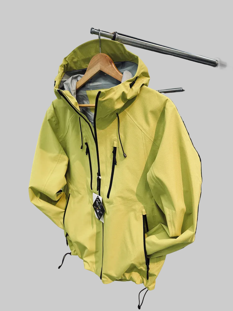 Load image into Gallery viewer, A lime green hooded rain jacket with black zippers and drawstrings hanging on a wooden hanger in a retail store.
