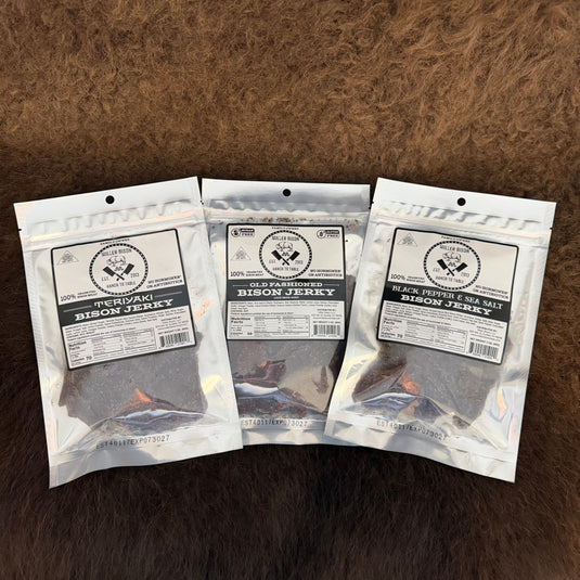 Three packages of Bison Jerky by Wild Horse Ranch are arranged side-by-side on a brown fur background.