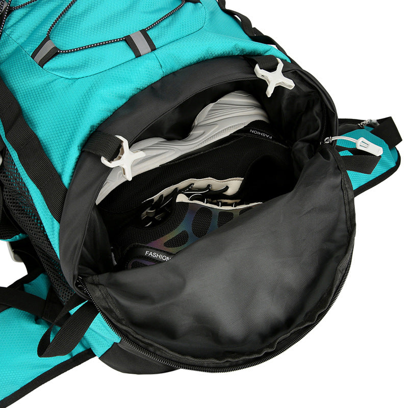 Load image into Gallery viewer, Open teal backpack with black interior showing a white shirt and black pants.
